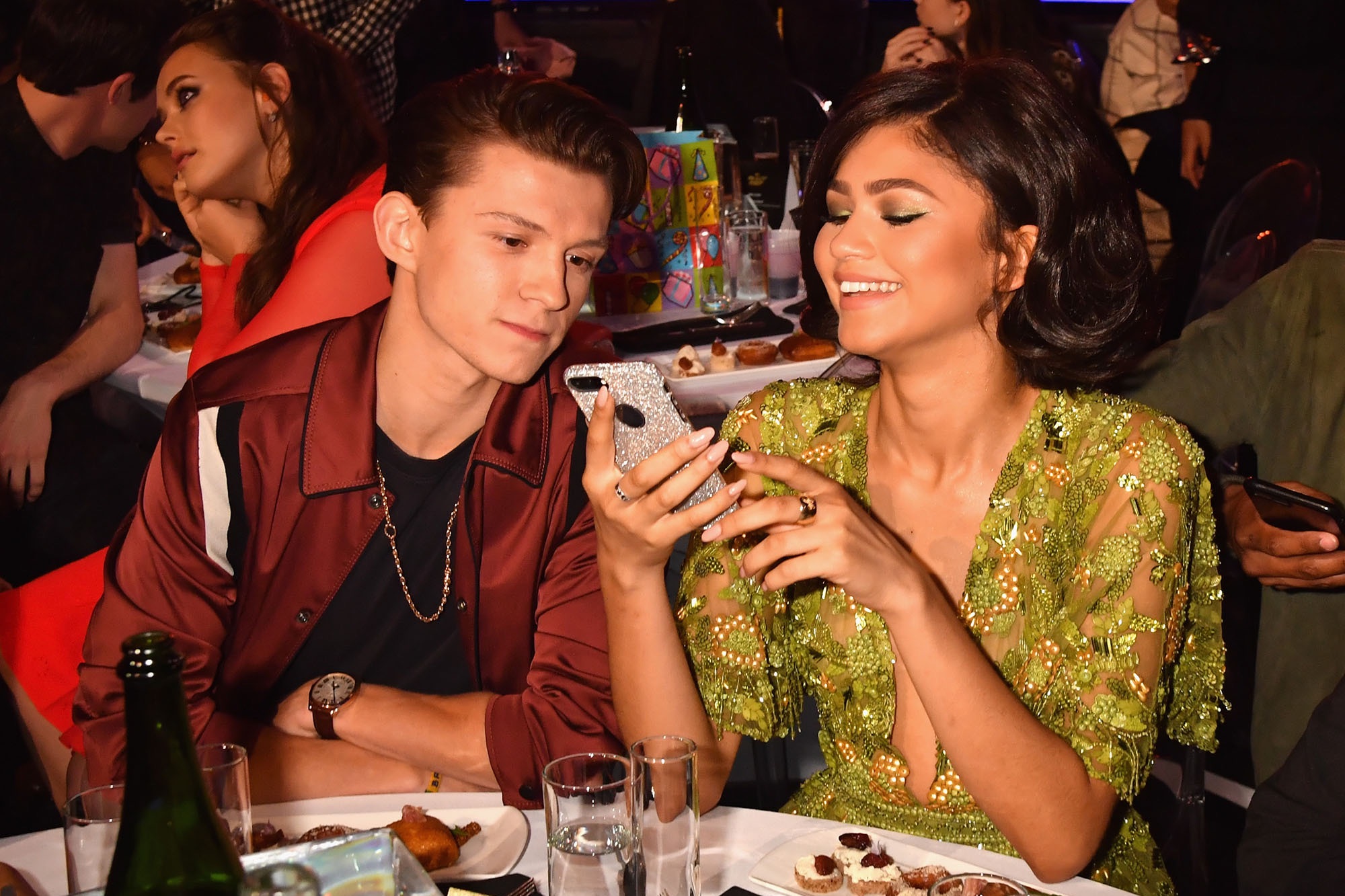 Tom Holland and Zendaya together watching a instagram post.